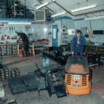 Mechanic working on a ski-doo in the garage at Rothera Research Station. Snow-mobiles are extensively used at the BAS stations and at remote field locations. These small vehicles are used for personal transport and for towing Nansen sledges. BAS operates Bombardier Ski-doos which are simple to ride with just a twist grip throttle and a brake. They have a fully automatic transmission and a track underneath with skis at the front to steer. Ski-doos can attain speeds of up to 50 mph on smooth snow.