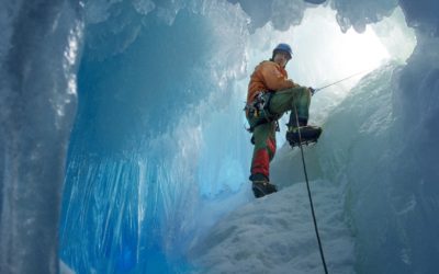British Antarctic Survey field assistant Rob Smith enters a crevasse alongside Reptile Ridge on Adelaide Island, Antarctica