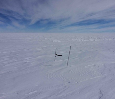 A man riding skis down a snow covered slope