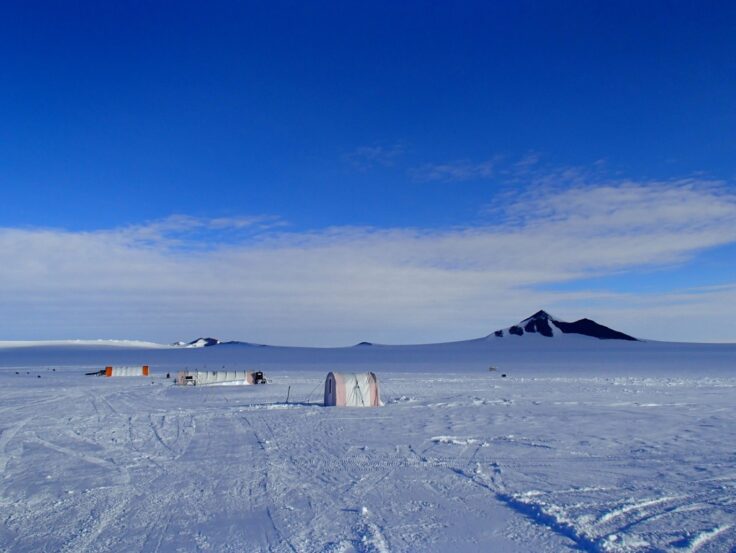 A group of people standing on top of a snow covered slope