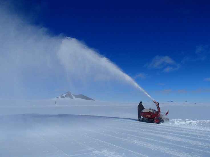 A man riding skis down a snow covered slope