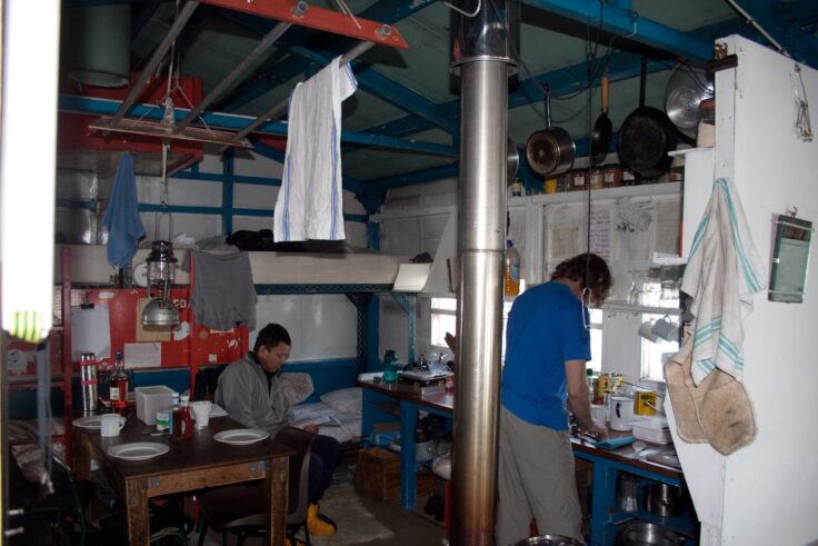 A group of people standing in a kitchen
