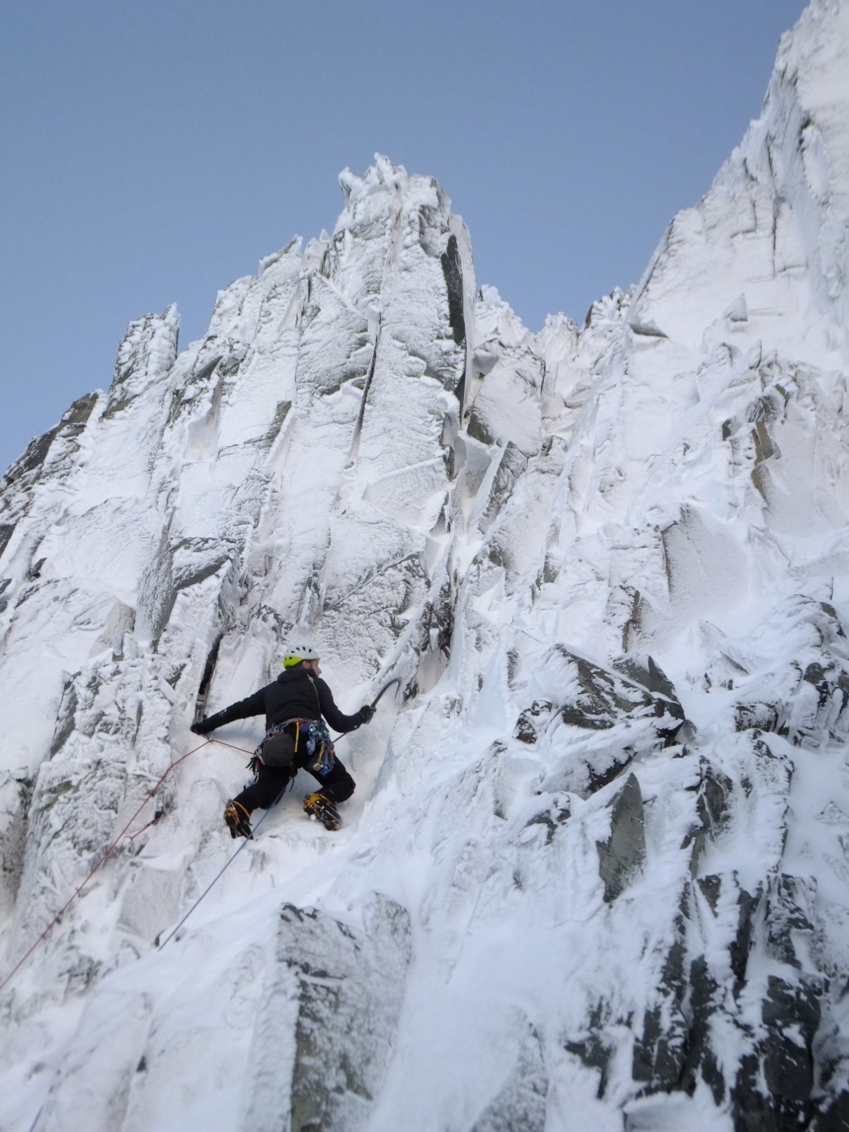 A man riding a snowboard down a snow covered slope