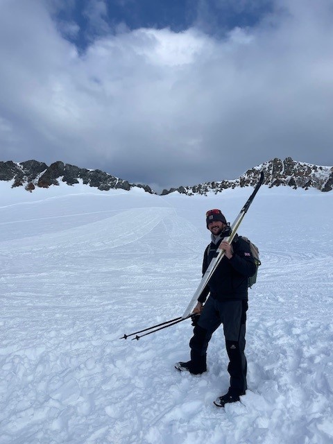 A man riding skis down a snow covered slope